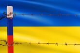 Flagsofrussianfederationandukrainedividedbybarbwire