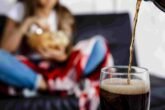 Woman Eating Chips Sitting Sofa Fosuc Glass Soda2 2