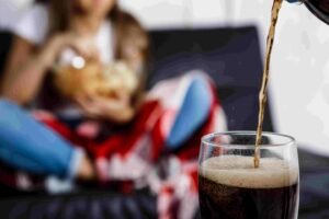Woman Eating Chips Sitting Sofa Fosuc Glass Soda2 2