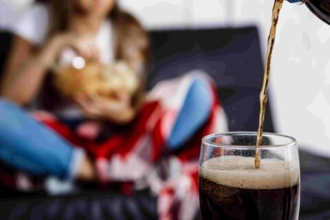 Woman Eating Chips Sitting Sofa Fosuc Glass Soda2 2