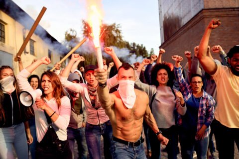 Angry Crowd Of People With Lit Torch On Public Demonstrations