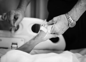 Husband Holding Hands Of His Wife In A Hospital