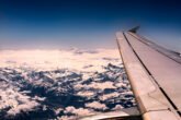 Closeup Shot Of An Airplane Wing And Mountains