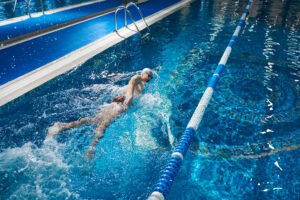 Sporty Male Swimming In Pool Night Workout
